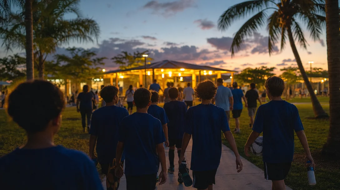 Youth players walking off the pitch at dusk in South Florida
